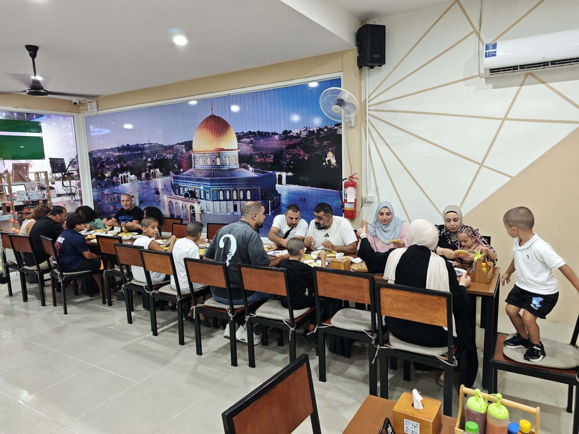 A family enjoying dinner together at Jerusalem Restaurant Patong